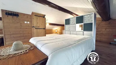 a bedroom with a large white bed in a room at Le moulin de cameliere in Caudebronde