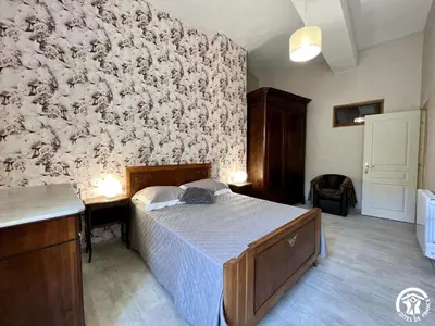 a bedroom with a bed and a wall at Chez madou in Roquefort-des-Corbières
