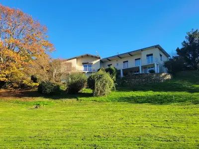 a large house on top of a green field at Appartement au cœur du golf in Pont-de-Larn