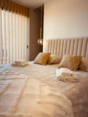a large bed with two towels on top of it at Villa moderne privée avec piscine, vue montagne 3 chambres in Pennautier