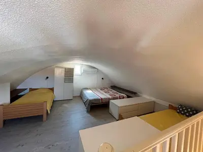 a small room with two beds and a staircase at Gruissan - T2 Mezzanine Climatisé - 6 Pers - Parking Proche Plage - FR-1-796-87 in Gruissan