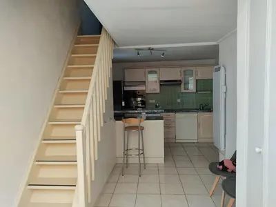 a kitchen with a staircase leading up to a kitchen at Gruissan - T2 Mezzanine Climatisé - 6 Pers - Parking Proche Plage - FR-1-796-87 in Gruissan