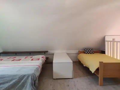 two beds in a room with white walls and wooden floors at Gruissan - T2 Mezzanine Climatisé - 6 Pers - Parking Proche Plage - FR-1-796-87 in Gruissan
