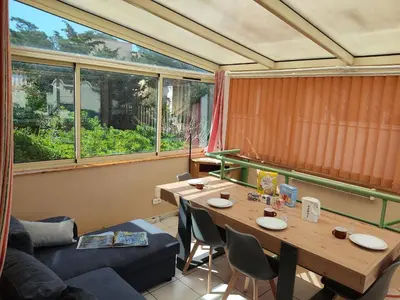 a room with a table and chairs and a couch at Gruissan - T2 Mezzanine Climatisé - 6 Pers - Parking Proche Plage - FR-1-796-87 in Gruissan