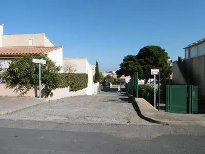 a street with a white building and a fence at Gruissan - T2 Mezzanine Climatisé - 6 Pers - Parking Proche Plage - FR-1-796-87 in Gruissan