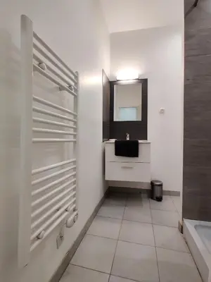 a bathroom with a sink and a mirror at Le Secret du Clocher in Pamiers