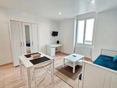 a living room with a couch and a table at Le Secret du Clocher in Pamiers