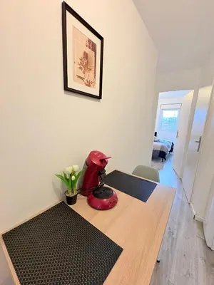 a red robot sitting on top of a table at Le Faubourg in Pamiers