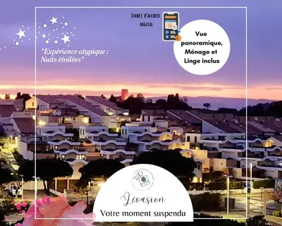 a view of a city at night with buildings at - L'Evasion - Vue panoramique in Gruissan
