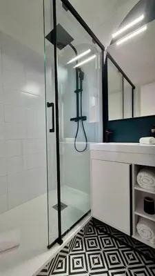 a bathroom with a glass shower and a sink at - L'Evasion - Vue panoramique in Gruissan
