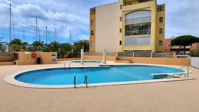 a large swimming pool in front of a building at - L'Evasion - Vue panoramique in Gruissan