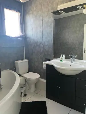 a bathroom with a sink and a toilet and a tub at Maison 3 chambres, piscine privée terrain de pétanque in Carcassonne
