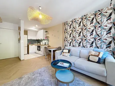 a living room with a couch and a table at Le Saint Just - Appartement face à la Cathédrale in Narbonne