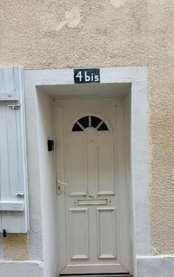 a white door with a sign on top of it at Sereni house jacuzzi in Narbonne