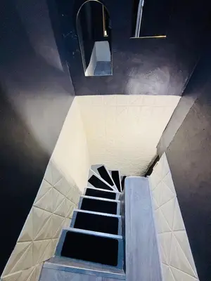 a staircase in a building with a stair case at Sereni house jacuzzi in Narbonne