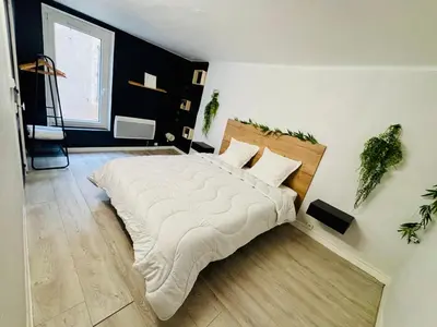 a bedroom with a large bed in a room at Sereni house jacuzzi in Narbonne