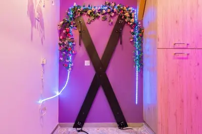 a large x sign on a pink wall at Le bridgerlove Tantra Jacuzzi Unique in Quillan