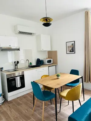 a kitchen and dining room with a table and chairs at L'atypique l 2 chambres l Clim in Castres