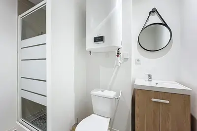 a small bathroom with a toilet and a sink at Bright 1-bedroom apartment in Cuxac-dʼAude