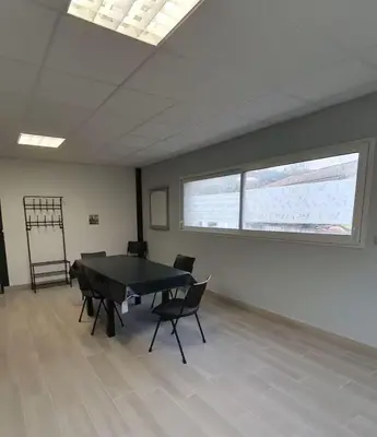 a large room with a table and chairs in it at la tanière argentée in Nailloux