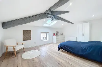 a bedroom with a bed and a ceiling fan at Spacious studio for two in Cuxac-d'Aude in Cuxac-dʼAude