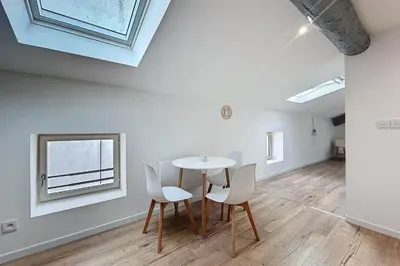 a room with a table and chairs and a window at Spacious studio for two in Cuxac-d'Aude in Cuxac-dʼAude
