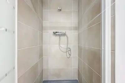 a bathroom with a shower with a glass door at Spacious studio for two in Cuxac-d'Aude in Cuxac-dʼAude