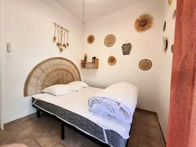 a small bed in a room with at Rez de jardin climatisé avec grande terrasse in Gruissan