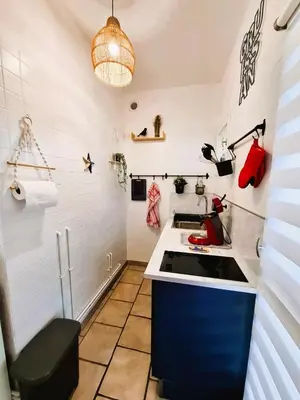 a kitchen with a sink and a counter top at Rez de jardin climatisé avec grande terrasse in Gruissan