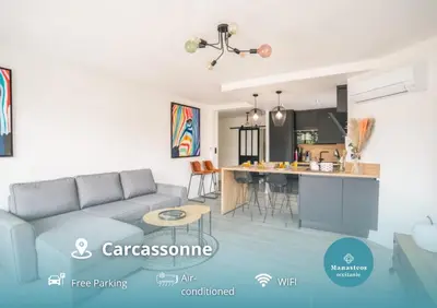 a living room with a couch and a kitchen at Magnifique T3-terrasse-parking-Centre ville-AD in Carcassonne