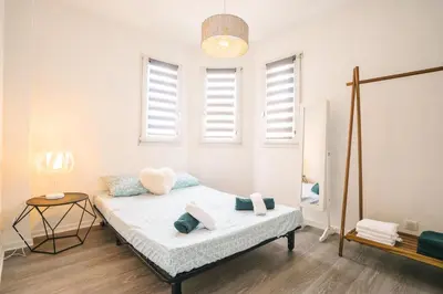 a bedroom with a bed and a mirror at Magnifique T3-terrasse-parking-Centre ville-AD in Carcassonne