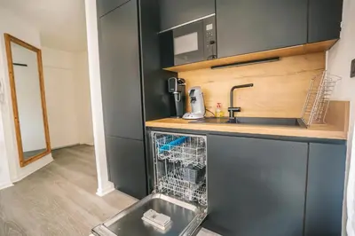 a dishwasher in a kitchen with a sink and a dish washer at Magnifique T3-terrasse-parking-Centre ville-AD in Carcassonne