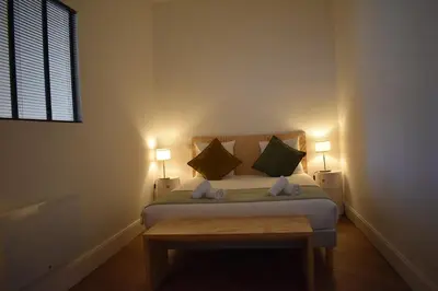 a bedroom with a bed with two pillows and a window at L'Opaline in Carcassonne