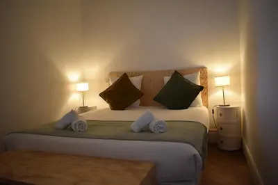 a bedroom with a large bed with two pillows at L'Opaline in Carcassonne