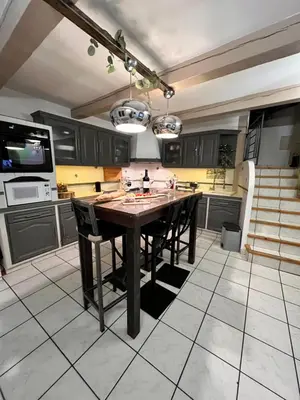a kitchen with a large wooden table and chairs at Charmante Maison de Village avec Terrasse in Olonzac