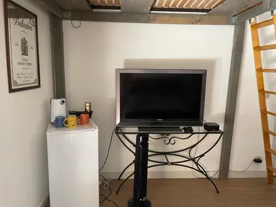a television sitting on a table in a room at Aux portes du Sidobre in Burlats