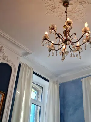 a chandelier in a room with a window at Le charme à la française - Appartement 4 pers in La Redorte