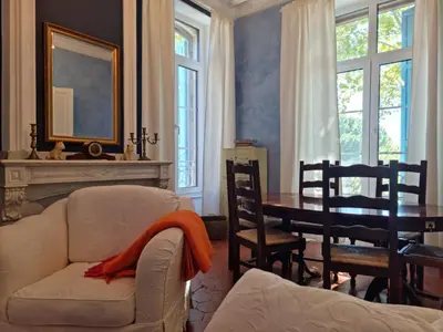 a living room with a white couch and a table at Le charme à la française - Appartement 4 pers in La Redorte