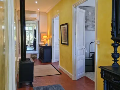 a hallway with a room with a wood stove at Le charme à la française - Appartement 4 pers in La Redorte