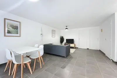 a living room with a table and a couch at Bright T3 for 4 people in Cuxac-dʼAude