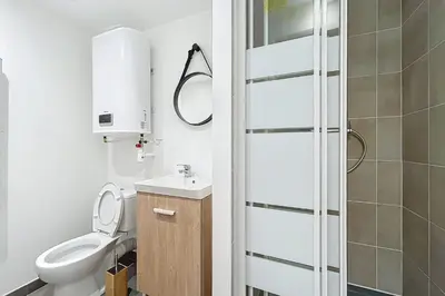 a bathroom with a toilet and a sink at Bright T3 for 4 people in Cuxac-dʼAude