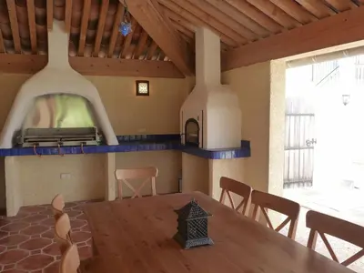 a room with a table and a bed on the wall at Charming cottage style property nestled in stunning French countryside near Carcassonne and Mirepoix in Hounoux