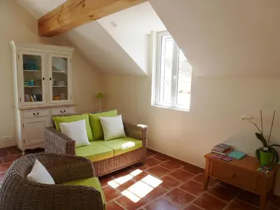 a living room with a couch and a table at Charming cottage style property nestled in stunning French countryside near Carcassonne and Mirepoix in Hounoux