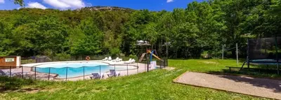 a swimming pool with a slide and a playground at Camping 2 étoiles - Piscine - ccb0hef in Fenouillet