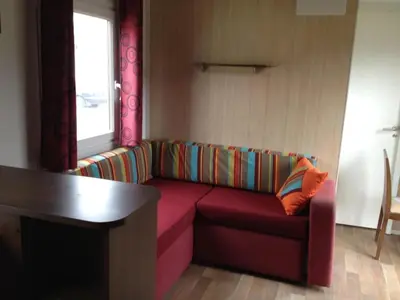 a restaurant with a bar with a chalkboard and a stool at Camping 2 étoiles - Piscine - ccb0hef in Fenouillet