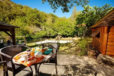 a deck with tables and chairs next to a pool at Camping 2 étoiles - Piscine - ccb0hef in Fenouillet