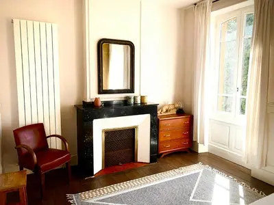 a living room with a fireplace and a mirror at 19Th Century Mansion With Pool Near Castres in Payrin-Augmontel