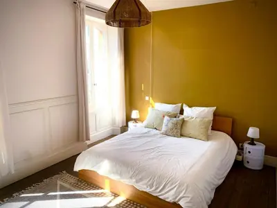 a bedroom with a white bed with a yellow wall at 19Th Century Mansion With Pool Near Castres in Payrin-Augmontel