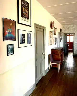 a hallway with a piano and pictures on the wall at 19Th Century Mansion With Pool Near Castres in Payrin-Augmontel
