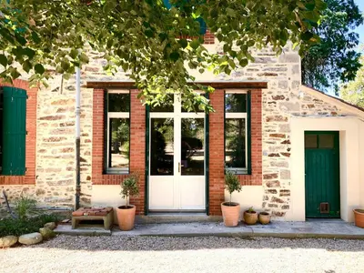 a brick house with a white door and windows at 19Th Century Mansion With Pool Near Castres in Payrin-Augmontel